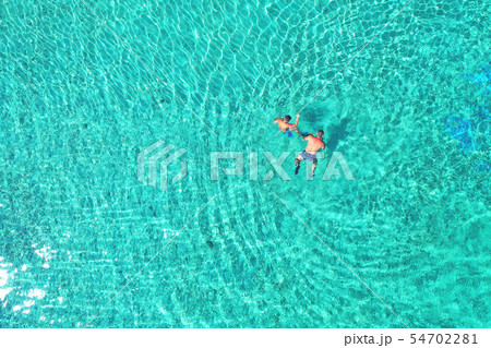 Father and son snorkels through tropical water Father and son snorkels through tropical water 54702281