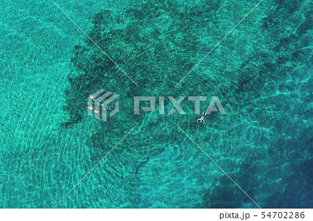 Father and son snorkels through tropical water Father and son snorkels through tropical water 54702286