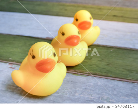 Rubber yellow ducks toy on wooden table background Rubber yellow ducks toy on wooden table background 54703117