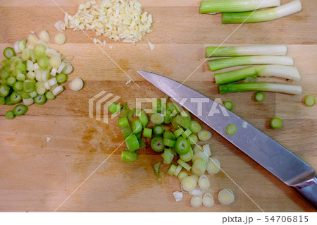 Chopped fresh green scallion on chopping board Chopped fresh green scallion on chopping board 54706815