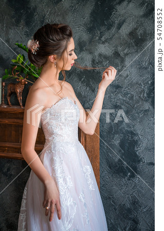 young bride in long dress posing for the camera 54708552