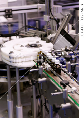 small glass medicine bottles on a packaging line 54708813