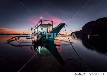 Long exposure with traditional Philippines boat at evening. Blue hour seascape Long exposure with traditional Philippines boat at evening. Blue hour seascape 54709031