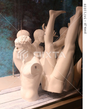 mannequin stands in a large store on a shop window 54711039