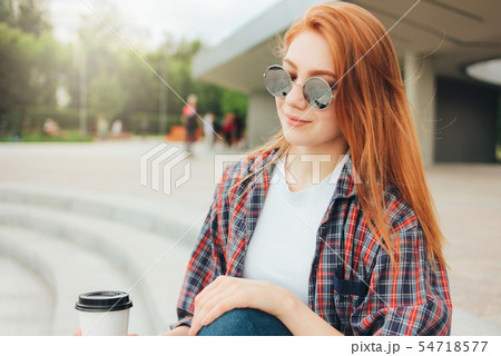 Attractive redhead smiling girl in round glasses 54718577