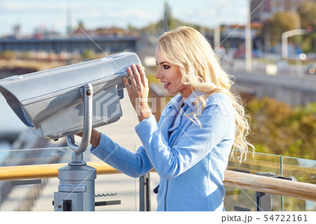 Cheerful young tourist using telescope  tower 54722161