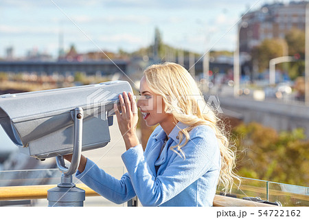 Cheerful young tourist using telescope  tower 54722162