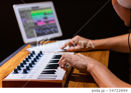 composer arranging music on keyboard and tablet pc composer arranging music on keyboard and tablet pc 54722694