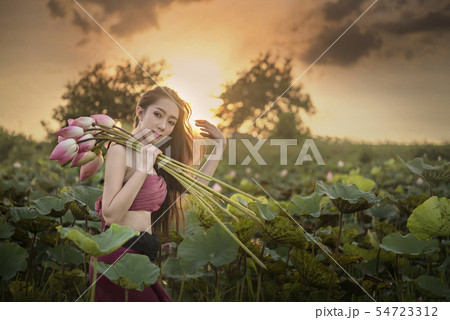 woman harvesting water lilies woman harvesting water lilies 54723312