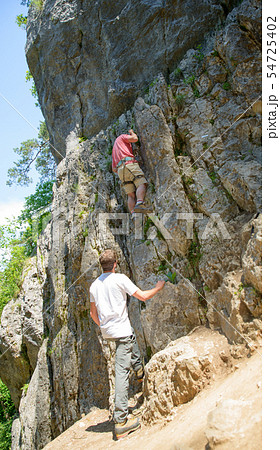 young man climbing young man climbing 54725402