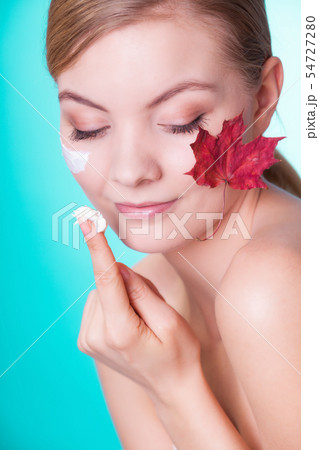 Skin care. Face of young woman girl with red maple Skin care. Face of young woman girl with red maple 54727280