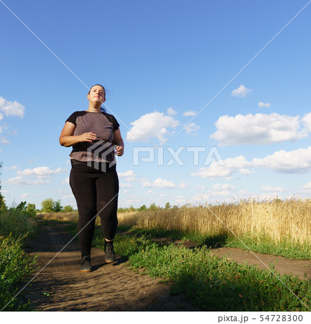 Overweight runner go jogging outdoors. Weight loss Overweight runner go jogging outdoors. Weight loss 54728300
