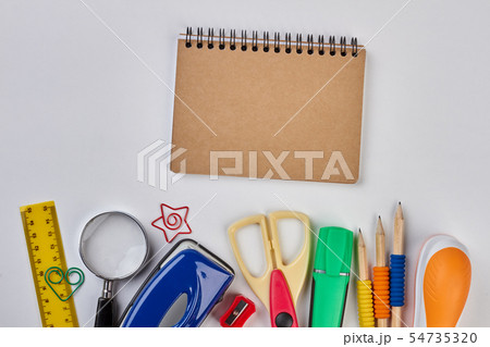 Notebook and school accessories on white background. Notebook and school accessories on white background. 54735320