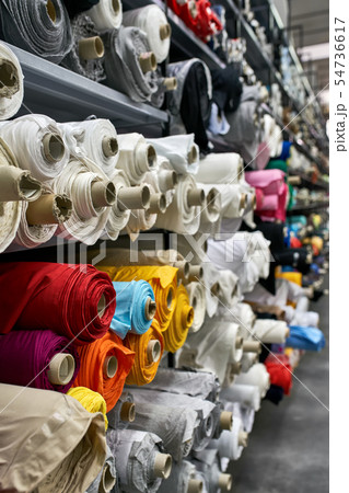 Fabric warehouse with many multicolored textile rolls 54736617