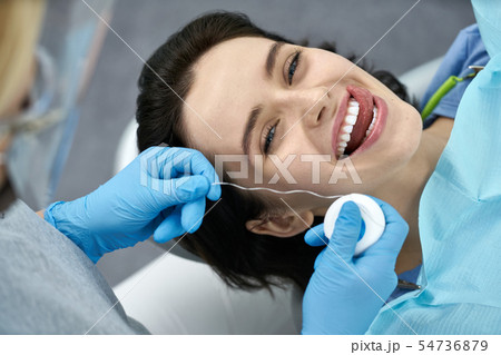 Pretty woman's teeth treatment in dental clinic 54736879
