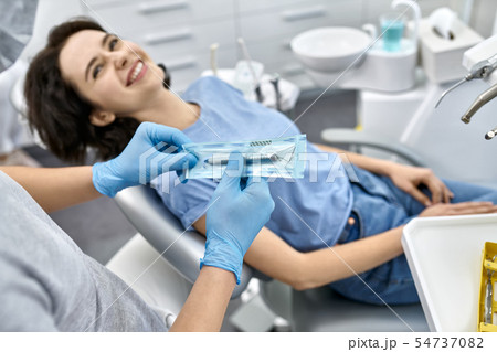 Pretty woman's teeth treatment in dental clinic 54737082