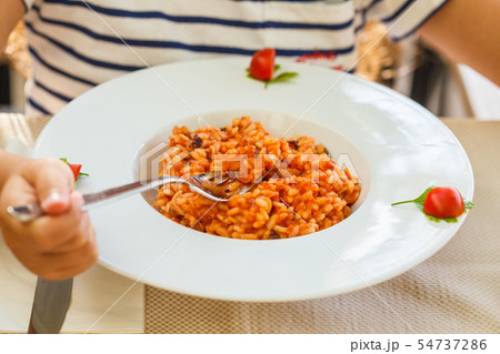 Risotto with seafood and tomato sauce Risotto with seafood and tomato sauce 54737286