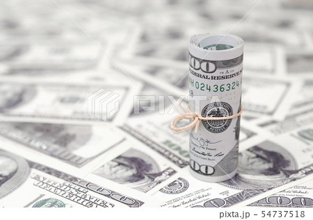 US dollars rolled up and tightened with band lies 54737518