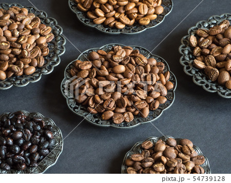 Varieties of roasted coffee beans on a black table Varieties of roasted coffee beans on a black table 54739128
