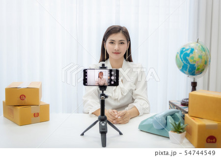 Young Asian woman as vlogger or blogger attending 54744549