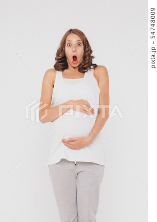 girl holds stomach with mouth wide open 54748009