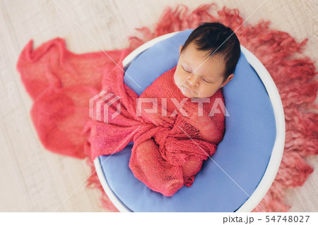 newborn baby wrapped in blanket sleeping in basket newborn baby wrapped in blanket sleeping in basket 54748027