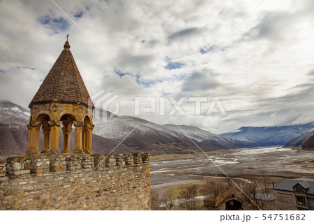 Old Castle Church in Cloudy Mountain Landscape 54751682