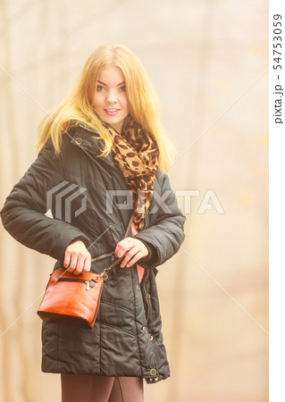 Woman walking in park in foggy day Woman walking in park in foggy day 54753059