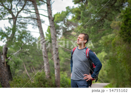 Male backpacker in the woods Male backpacker in the woods 54755102