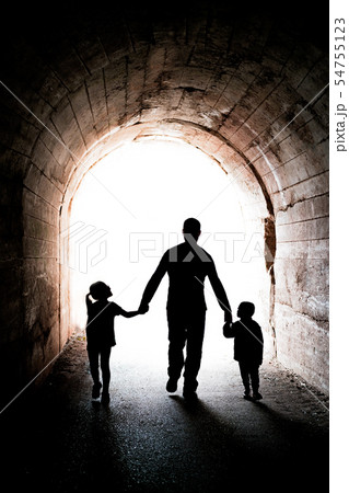 Father walking with his two children in a tunnel Father walking with his two children in a tunnel 54755123