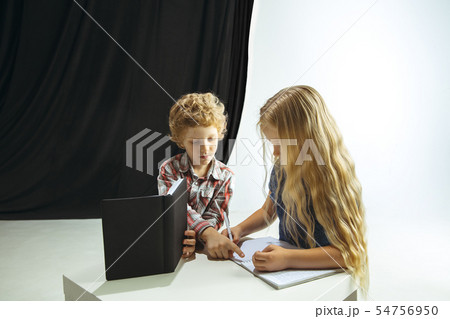 Boy and girl preparing for school after a long summer break. Back to school. Boy and girl preparing for school after a long summer break. Back to school. 54756950