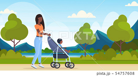 mother with toddler son in stroller walking outdoor african american woman pushing pram with child mother with toddler son in stroller walking outdoor african american woman pushing pram with child 54757608