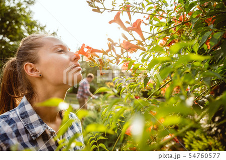 Young and happy farmer's couple at their garden in sunny day Young and happy farmer's couple at their garden in sunny day 54760577