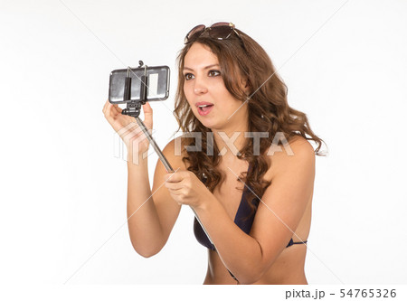 Woman in swimsuits taking a selfie. Woman in swimsuits taking a selfie. 54765326