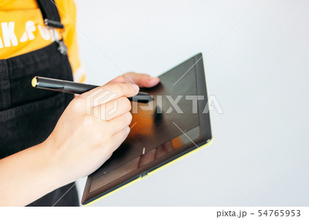 Graphic tablet with pen in hands of young woman 54765953