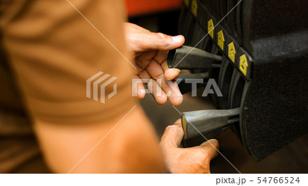 Technician hand is controlling the lifting crane. 54766524