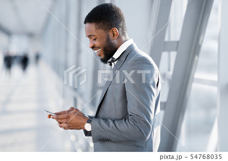 Always in Touch. Businessman Texting on Phone, Waiting for Flight 54768035