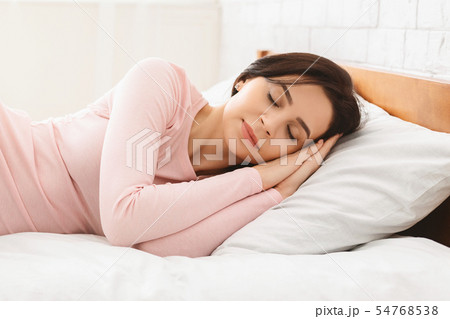 Beautiful young woman sleeping in her bed 54768538