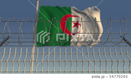 National flag of Algeria behind barbed wire fence. Conceptual 3D rendering 54770203