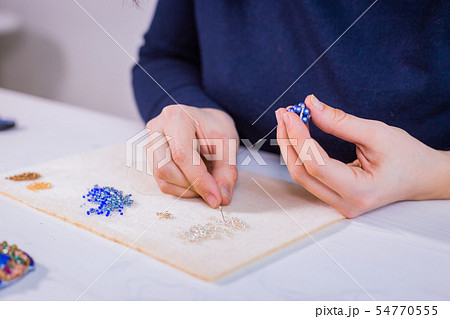 Designer making handmade eardrop Designer making handmade eardrop 54770555