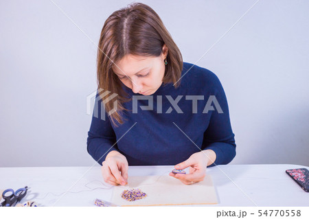 Designer making handmade brooch Designer making handmade brooch 54770558