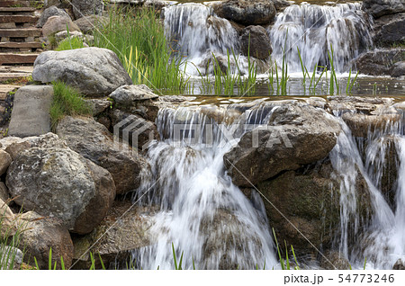 Waterfall between stone boulders, landscape design 54773246