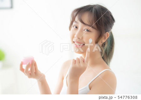beautiful young asian woman happy applying cream 54776308