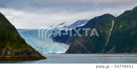 Distant panoramic view of a Holgate glacier with waterfall on the side in Kenai fjords National Park 54776451
