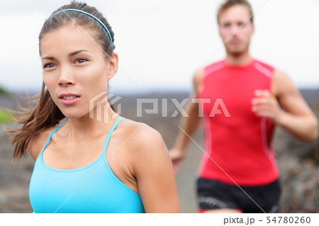 Woman runner closeup - running couple Woman runner closeup - running couple 54780260