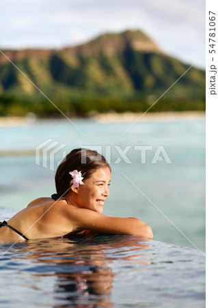 Travel vacations woman on holiday at beach resort 54781067