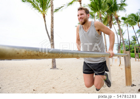 Bodyweight exercises man workout on dips bars Bodyweight exercises man workout on dips bars 54781283