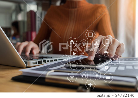 women is using smart phone at office. 54782140