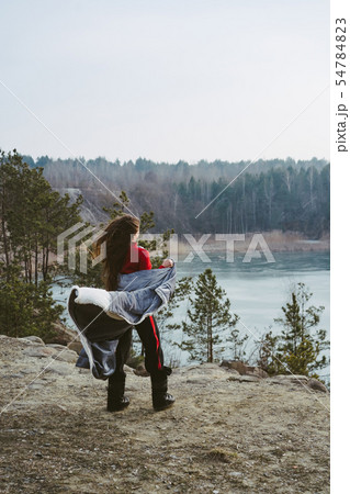 Young beautiful girl posing on a background of lake Young beautiful girl posing on a background of lake 54784823
