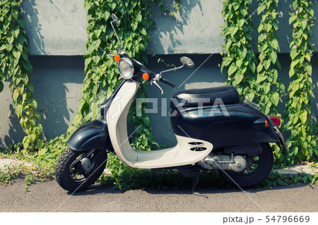 Parked moped against the wall. Parked moped against the wall. 54796669